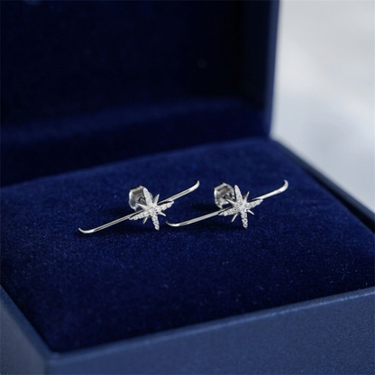 North Star suspender stud earrings in rhodium-tone, two starburst styles in box