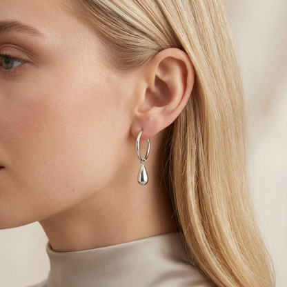 Silver teardrop hoop earrings worn, circular hoops with teardrop drops
