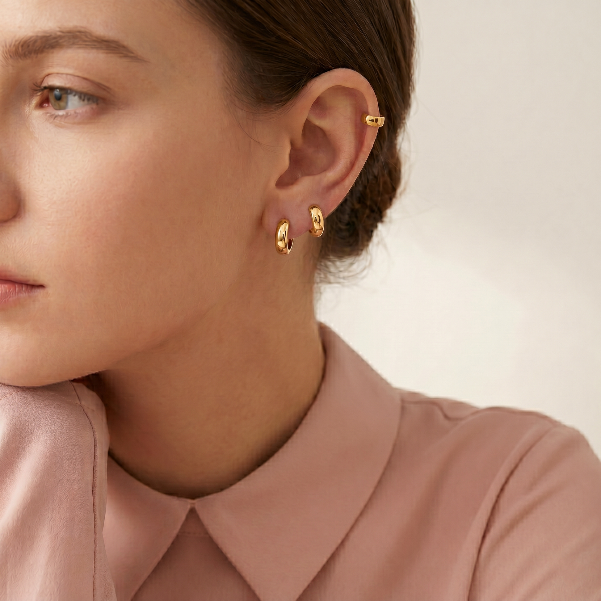 Bold 3mm sleeper huggies hoop earrings in gold, worn on ear