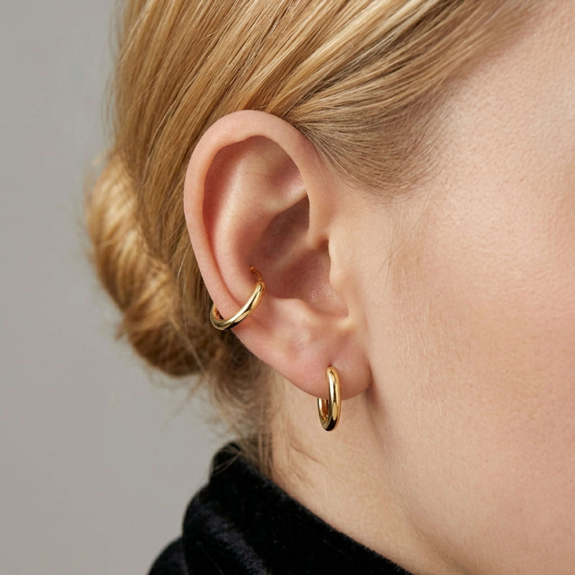 18K Gold 2mm sleeper huggies on ear, two small round hoop earrings