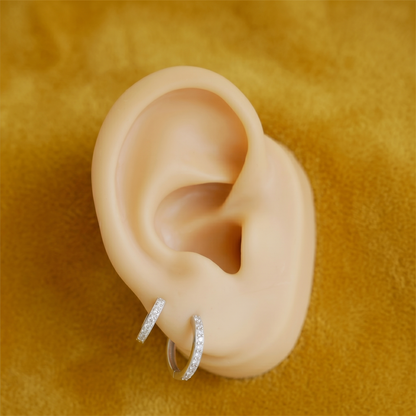 Small hoop earring with clear pavé stones and a thin bar detail