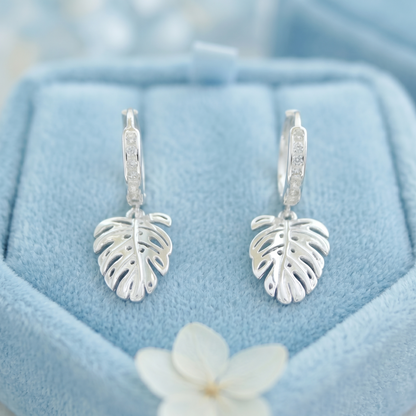 Monstera Leaf Drop Huggies: leaf charms hanging from crystal-studded hinged hoops