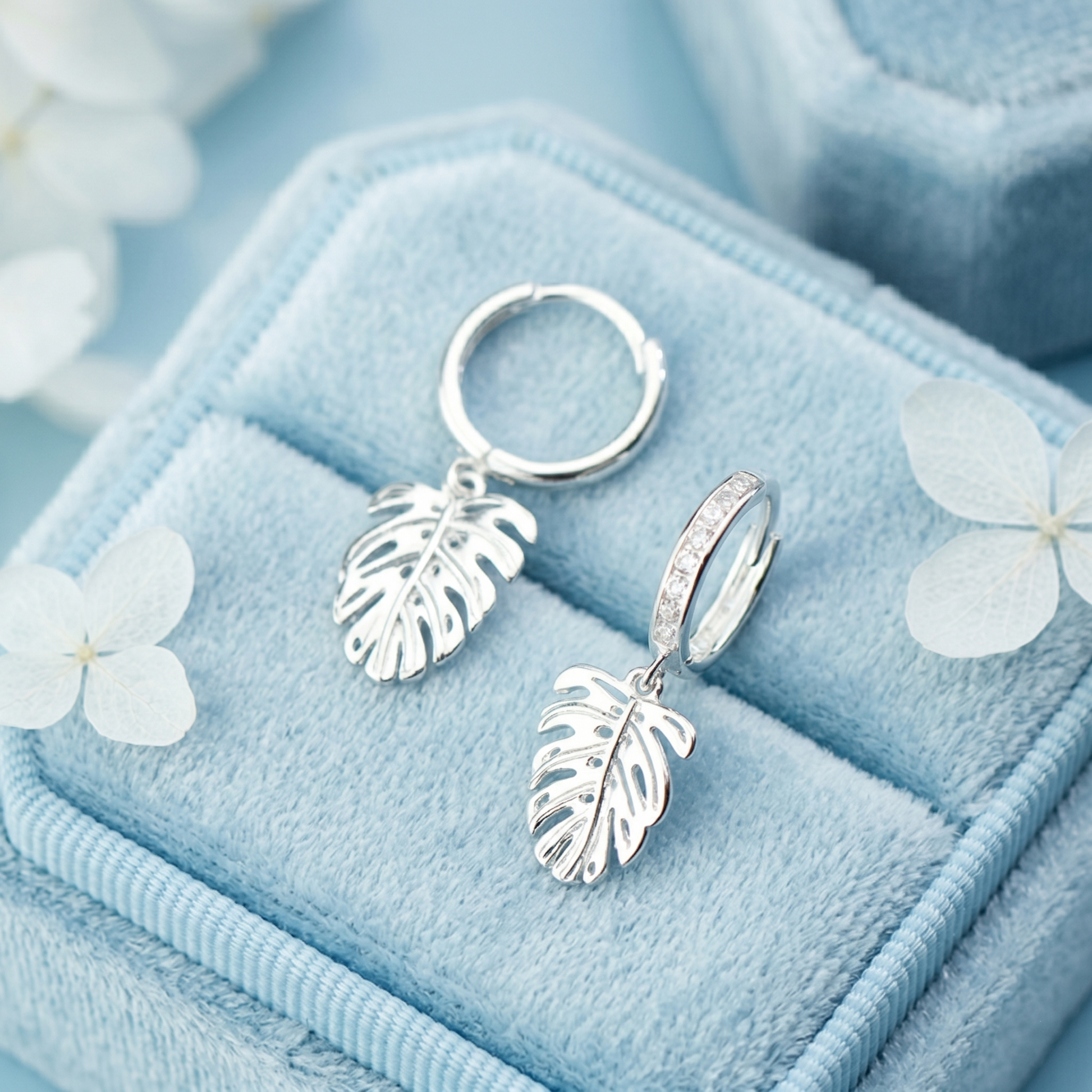 Monstera Leaf Drop Huggies: small hinged hoops with clear-stone band and leaf drops