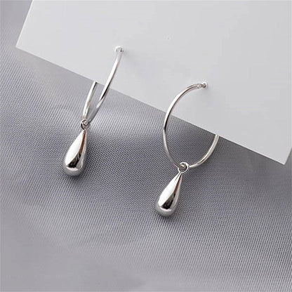 Silver teardrop hoop earrings, angled view with hanging drop details