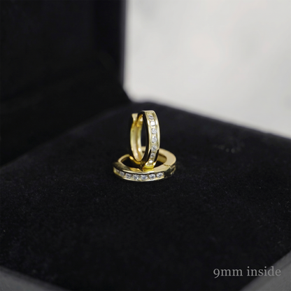 Gold huggie hoop earrings with stone row, inner edge visible