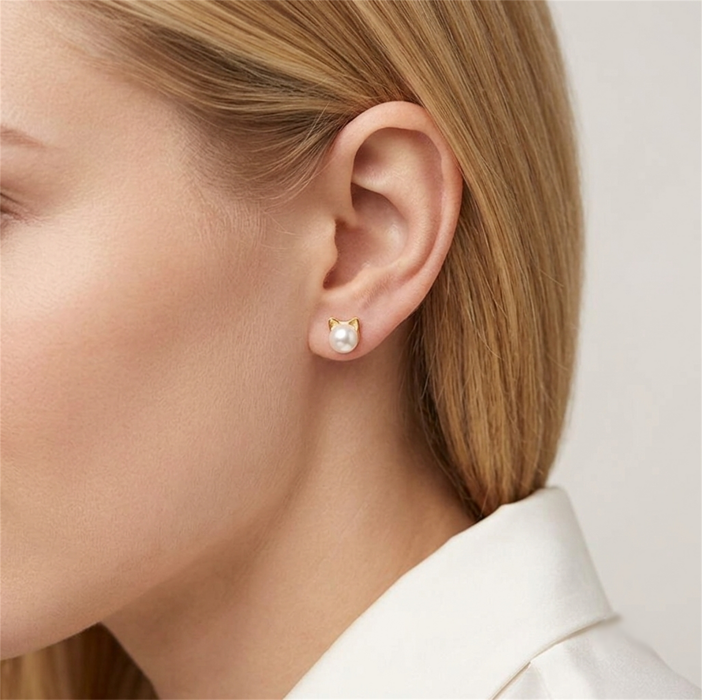 Cat pearl stud earrings on model with small round white pearls and cat ear setting