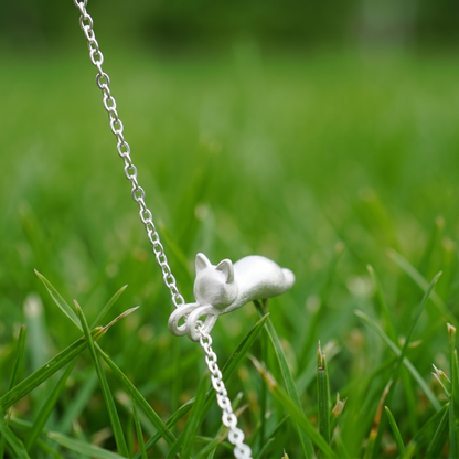 Cat pendant necklace with small curled-tail cat charm on silver chain
