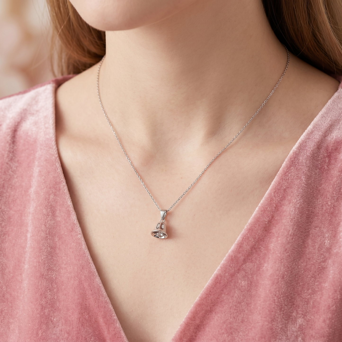 Jingle bell pendant necklace on model, glossy silver bell charm with loop bail