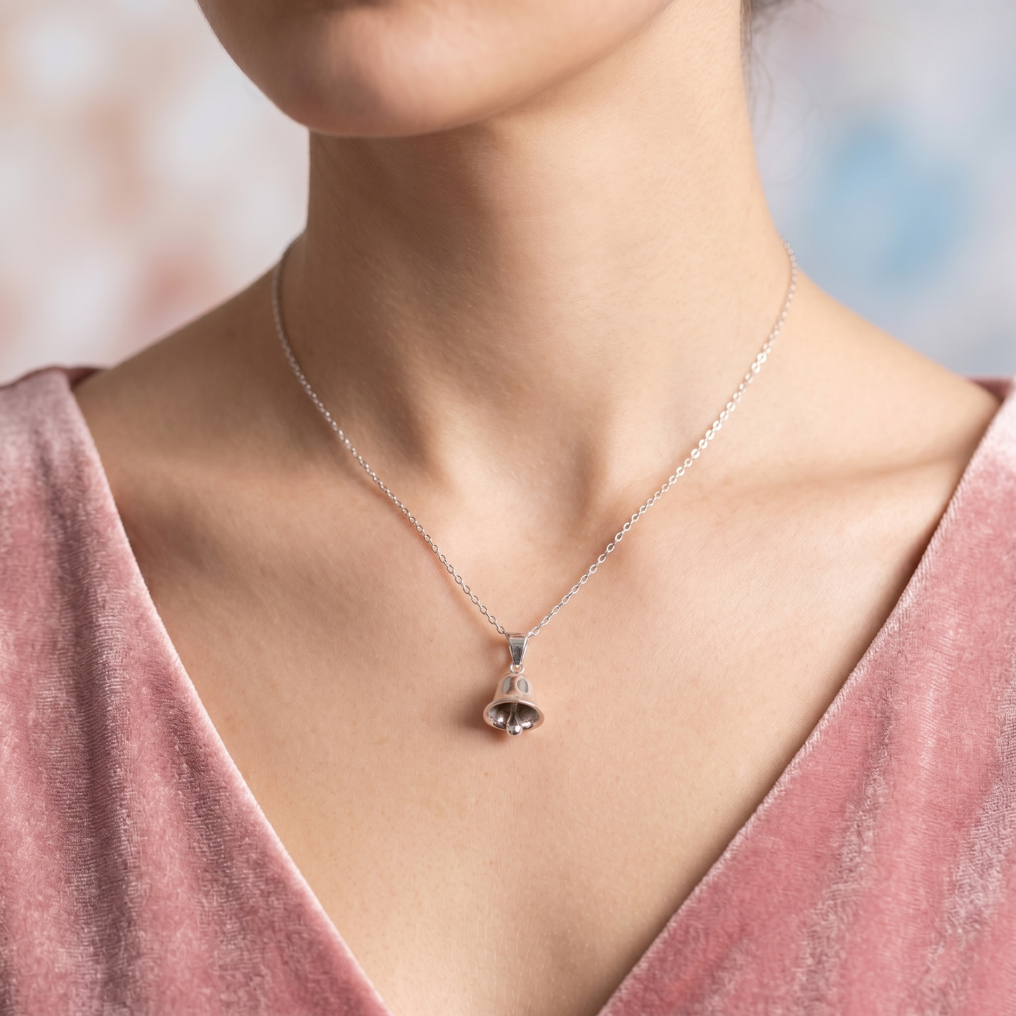 3D jingle bell pendant necklace on neck, polished silver bell charm on chain