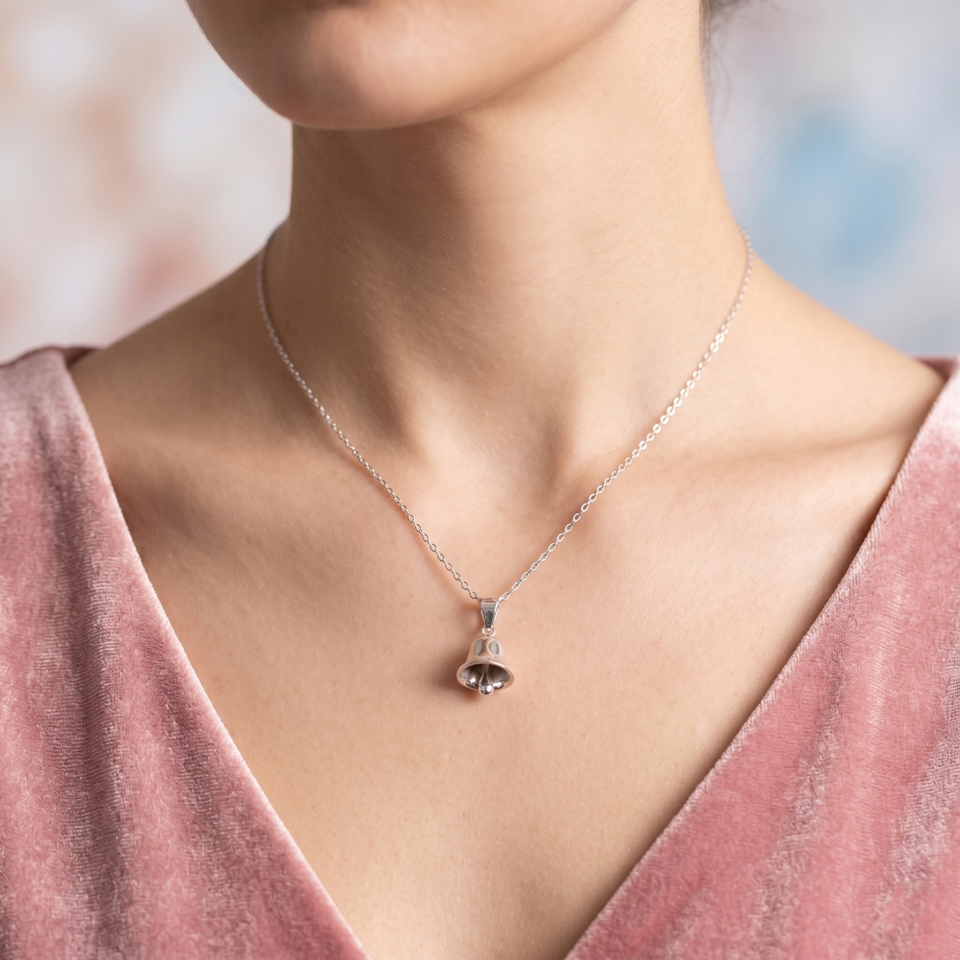 3D jingle bell pendant necklace on neck, polished silver bell charm on chain