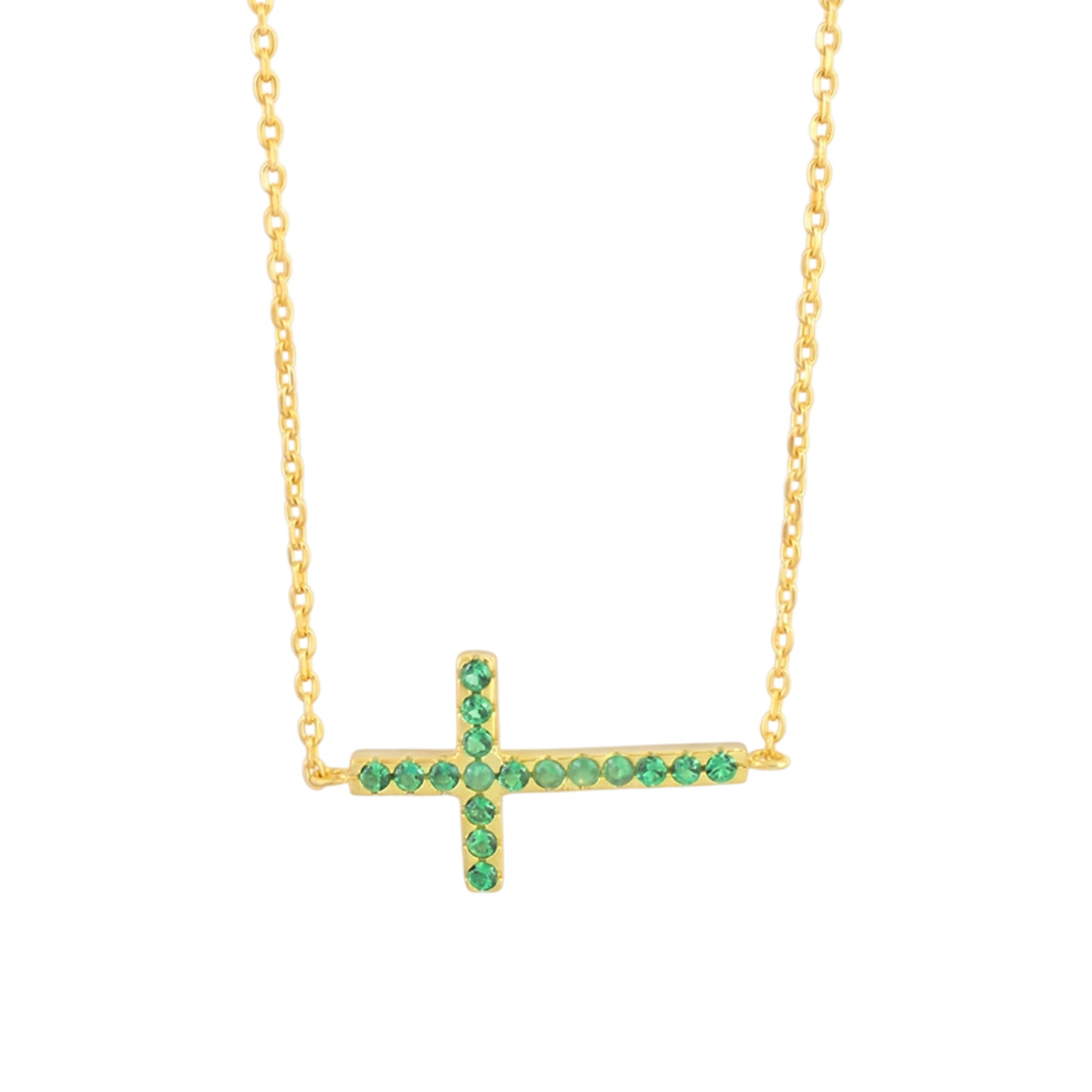 Sideways cross CZ necklace with green stones on a gold-tone chain