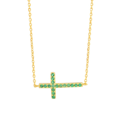 Sideways cross CZ necklace with green stones on a gold-tone chain