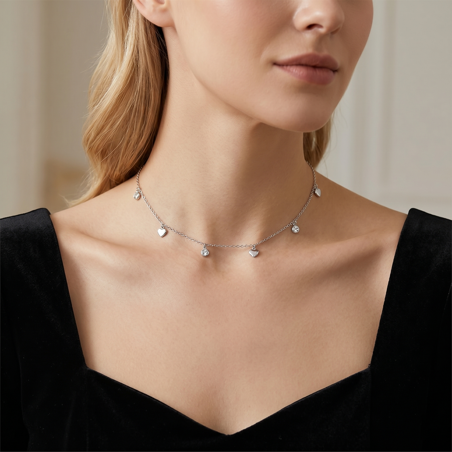 Mini heart CZ choker on model’s neck with heart charms and round CZ sparkles