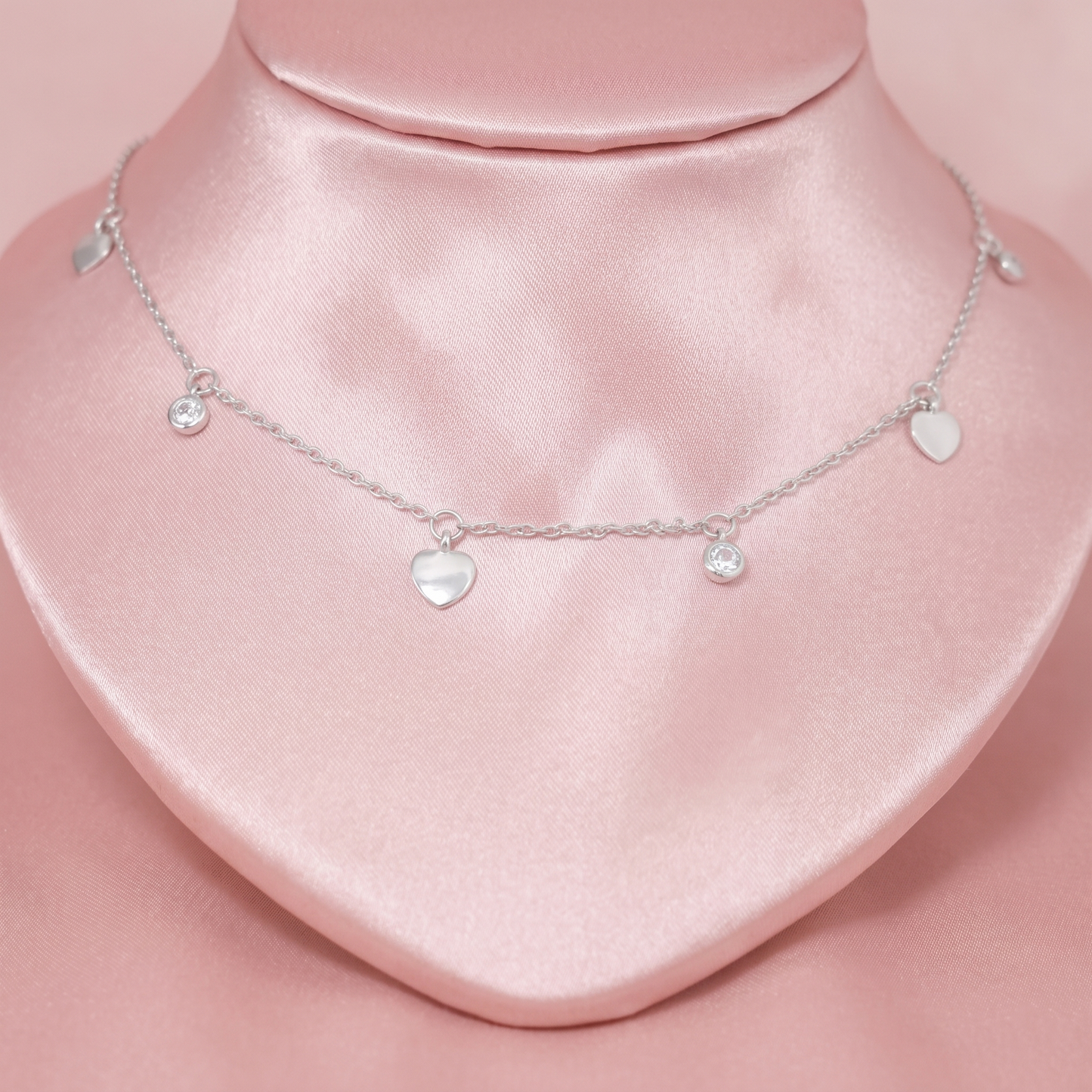 Heart CZ choker showing three mini hearts and round CZ charms on a silver chain