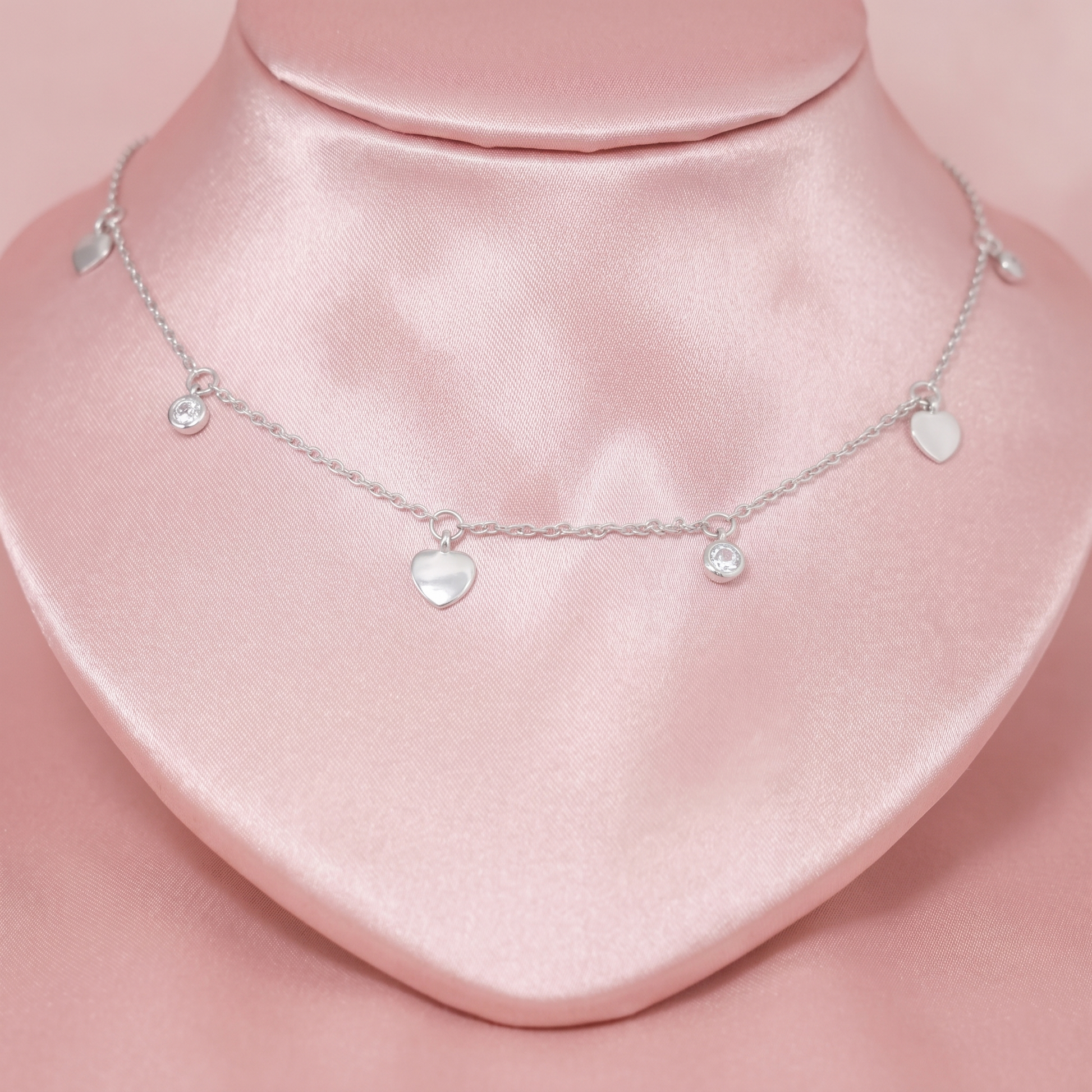Heart CZ choker showing three mini hearts and round CZ charms on a silver chain