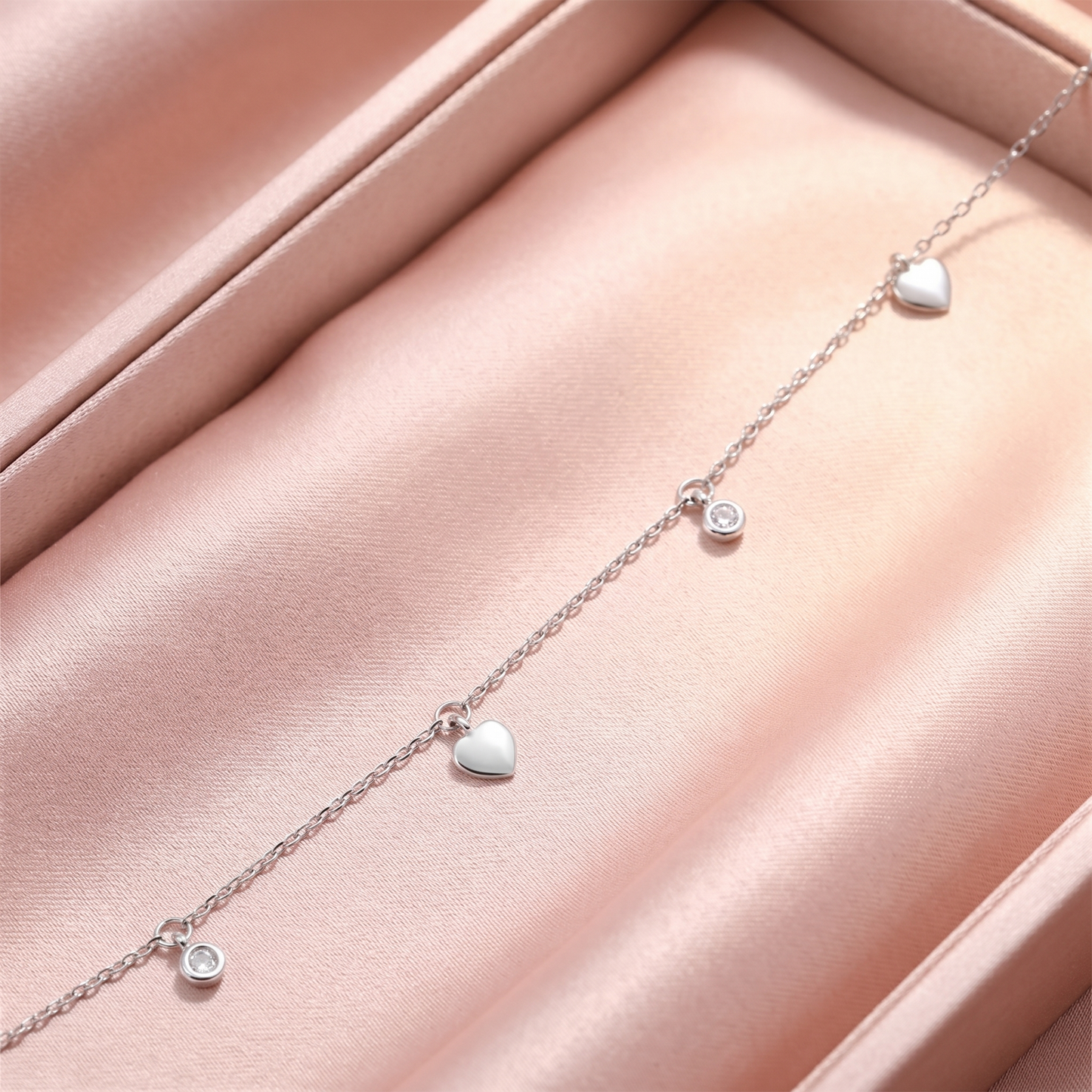 Close-up of mini heart CZ choker links with white heart charms and round CZ discs