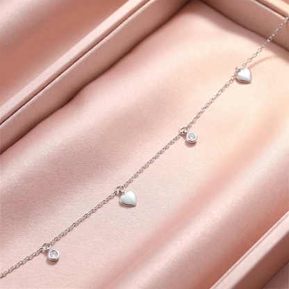 Close-up of mini heart CZ choker links with white heart charms and round CZ discs