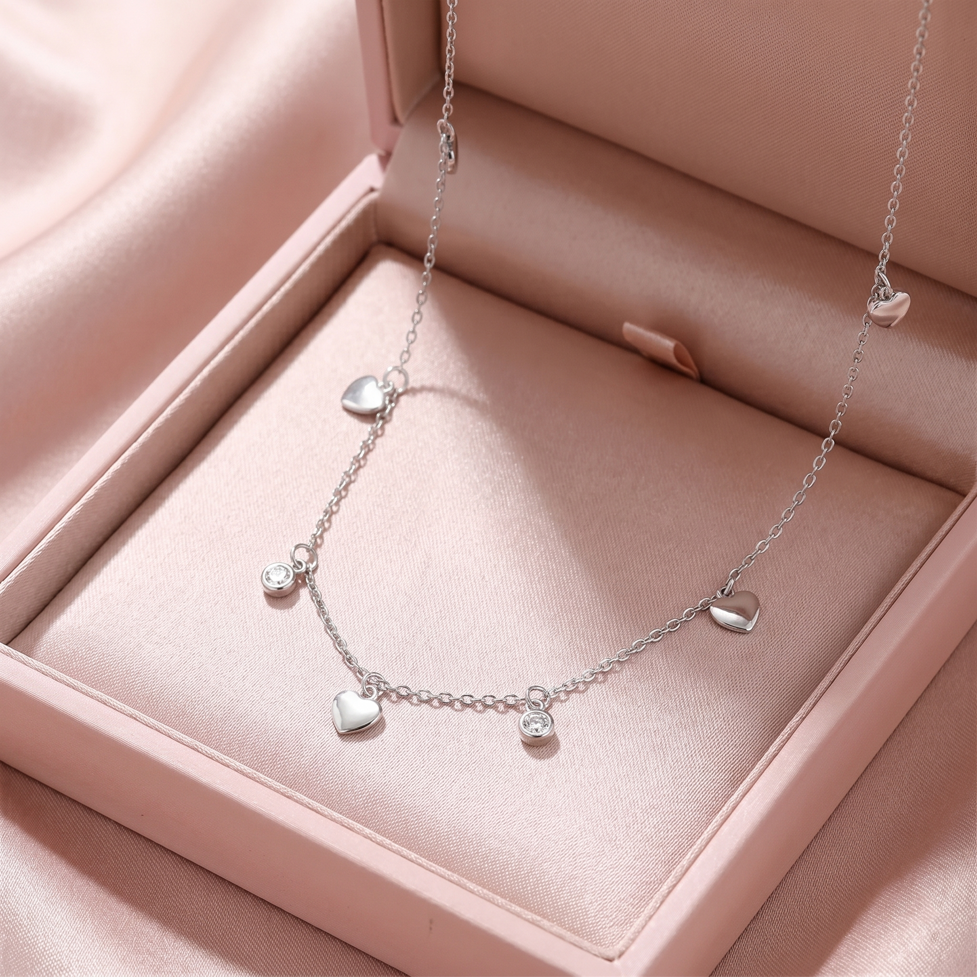 Silver-tone mini heart CZ choker with five heart charms and small round CZ discs