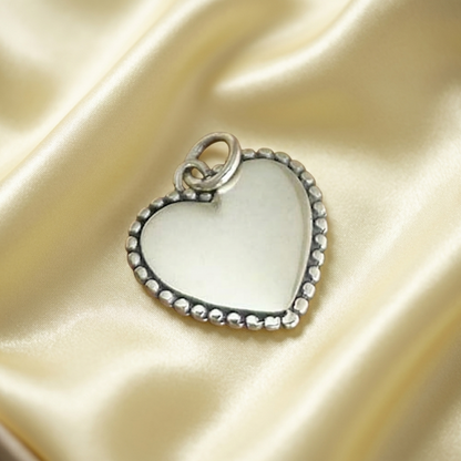Heart charm pendant with beaded rim, round bezel, and hanging loop