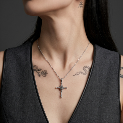 Oxidised Rose Thorn Cross pendant necklace worn on a model, twisted cross with rose center