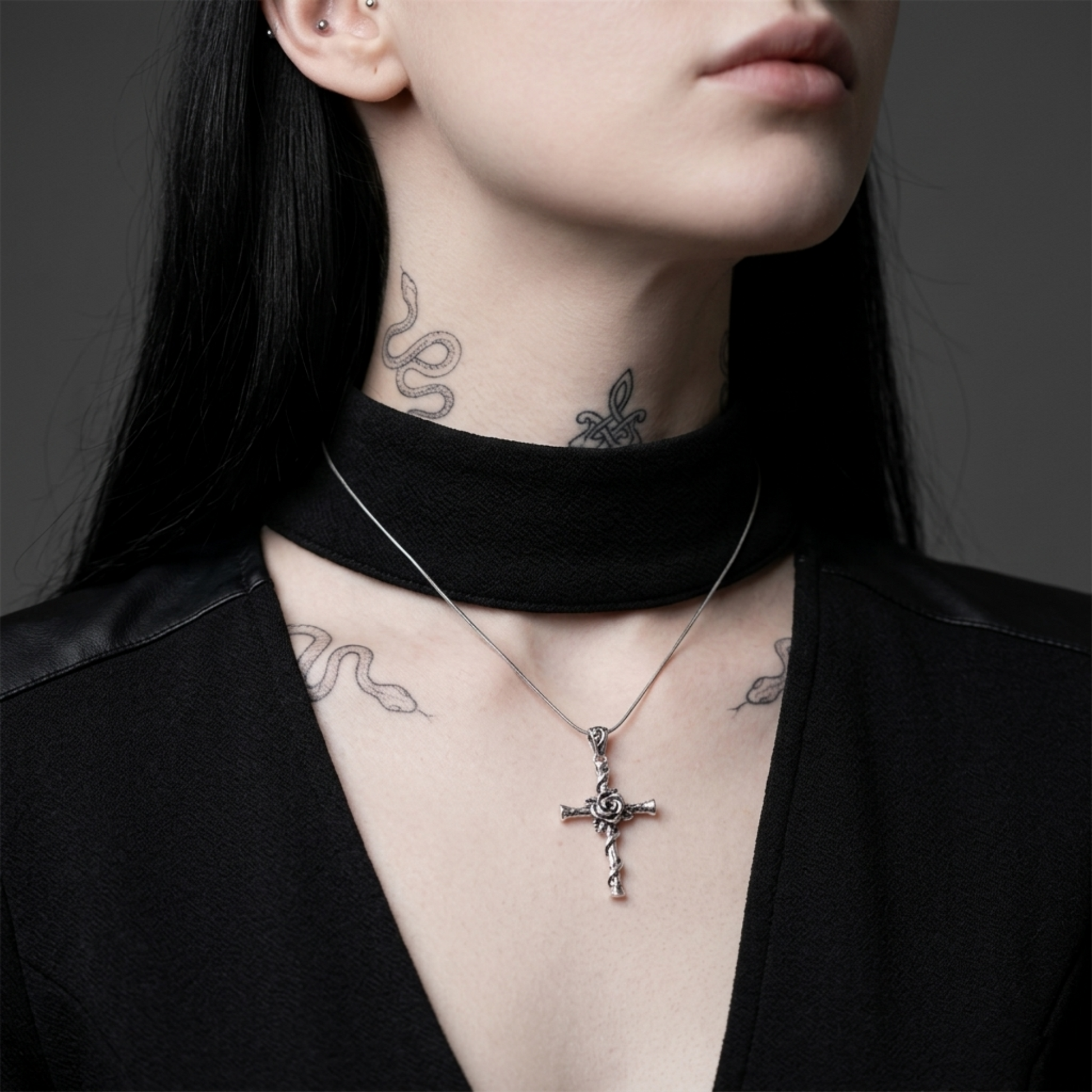 Oxidised Rose Thorn Cross pendant necklace worn, twisted cross charm hanging from chain