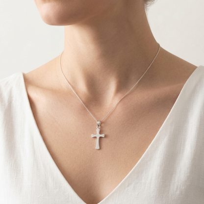 Flared cross pendant necklace on a chain, polished silver cross
