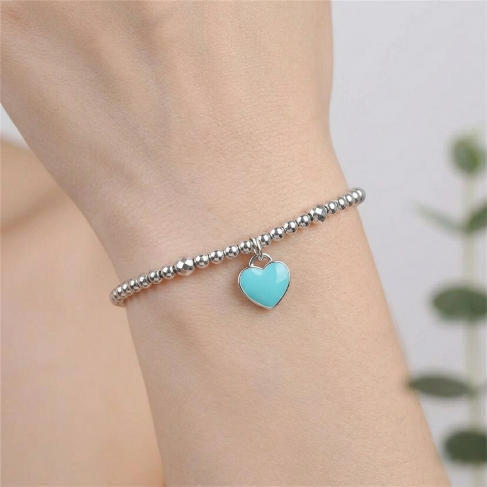 Heart charm bracelet with a turquoise glazed heart bead on silver beads