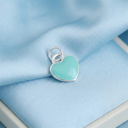 Turquoise glazed heart charm with silver loop, heart-shaped frame