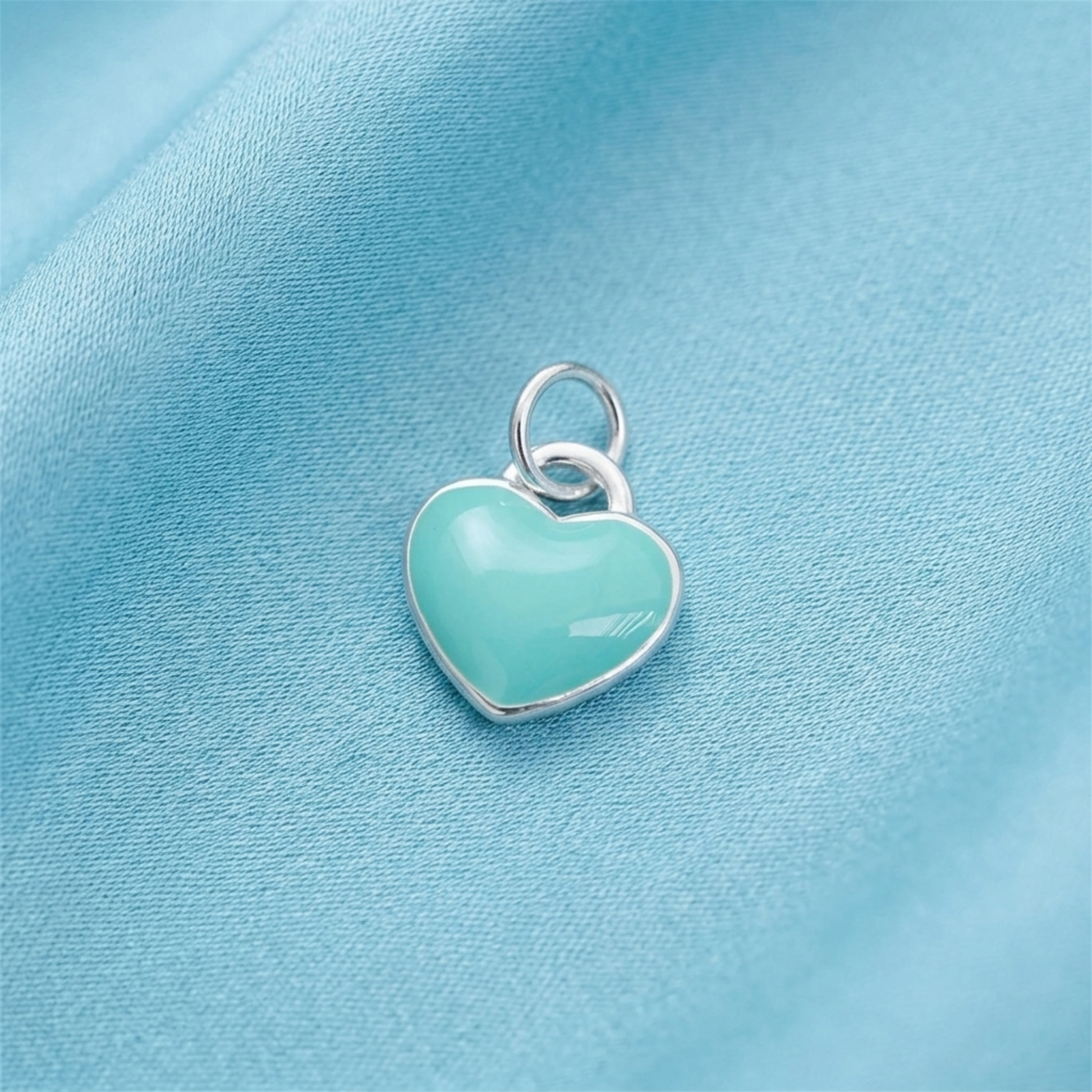 Turquoise glazed puffy heart charm on a silver loop