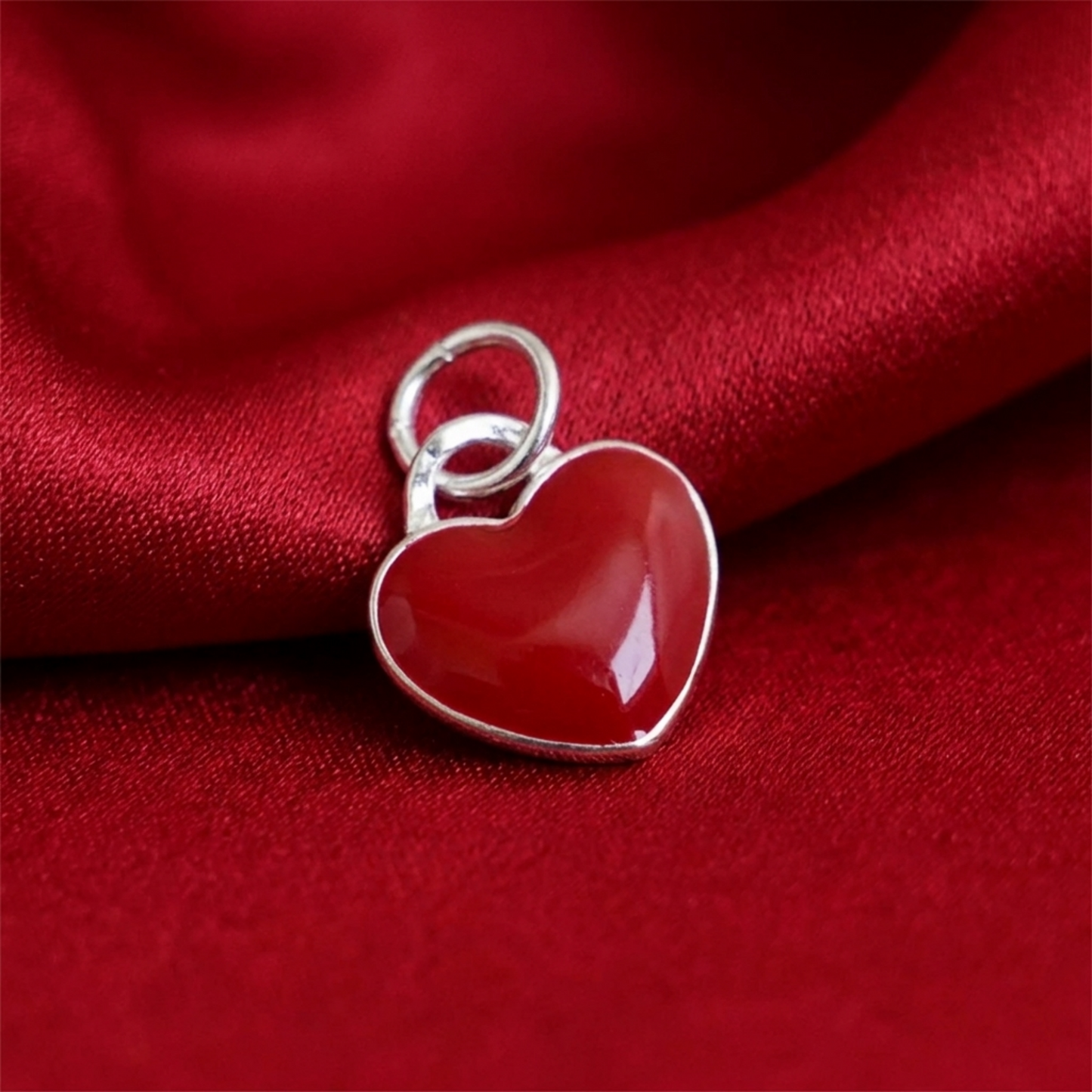Red heart charm on metal bail, glossy glazed enamel heart