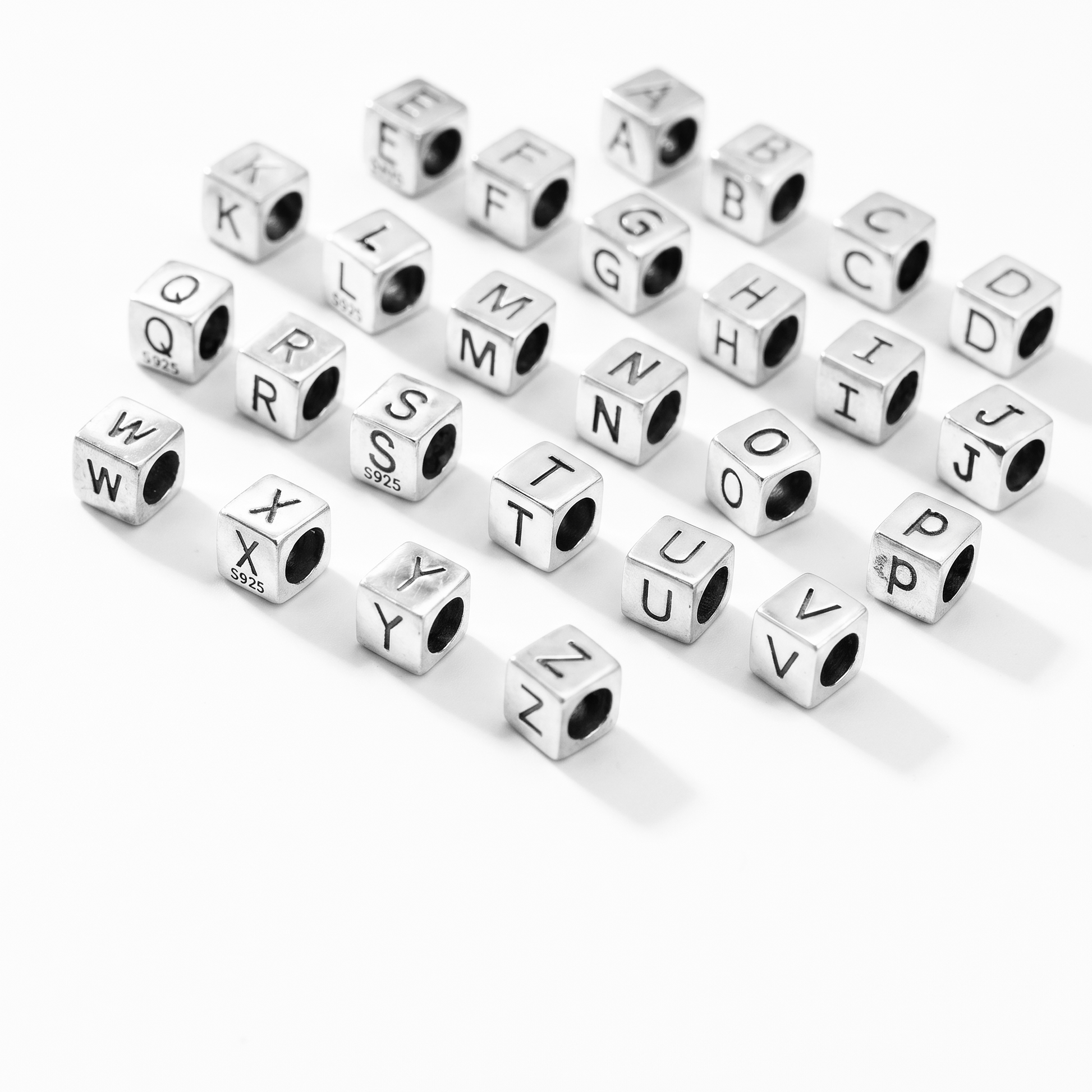 Alphabet cube beads scattered, stainless cubes with engraved letters (various A–Z)