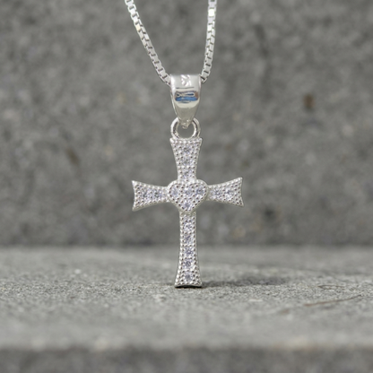 CZ heart cross pendant hanging on chain, silver-tone cross with pavé heart center