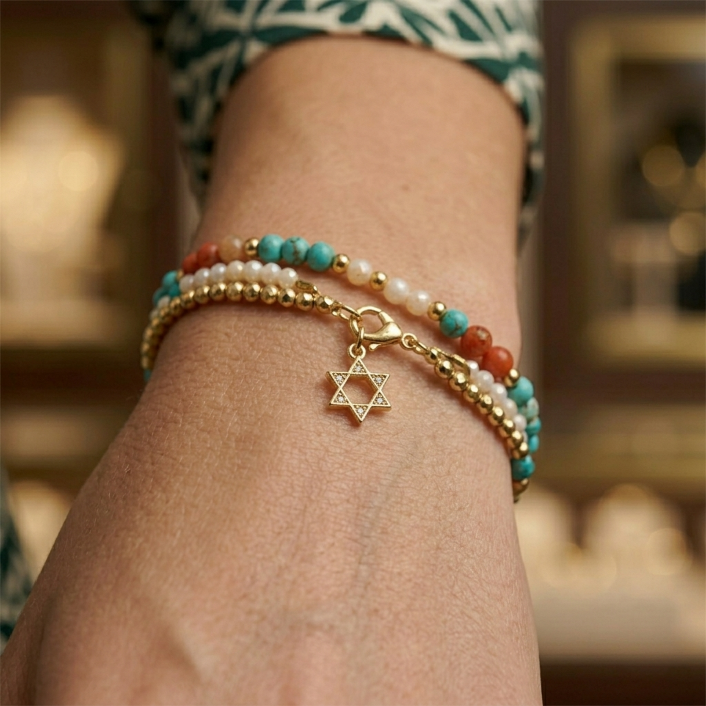 Gold-tone Star of David charm on a bracelet, hexagram with stone details