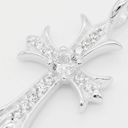 Silver CZ cross pendant close-up with large center stone and pavé details