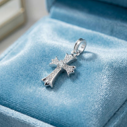 Silver CZ cross pendant on a blue display with round-cut crystal details