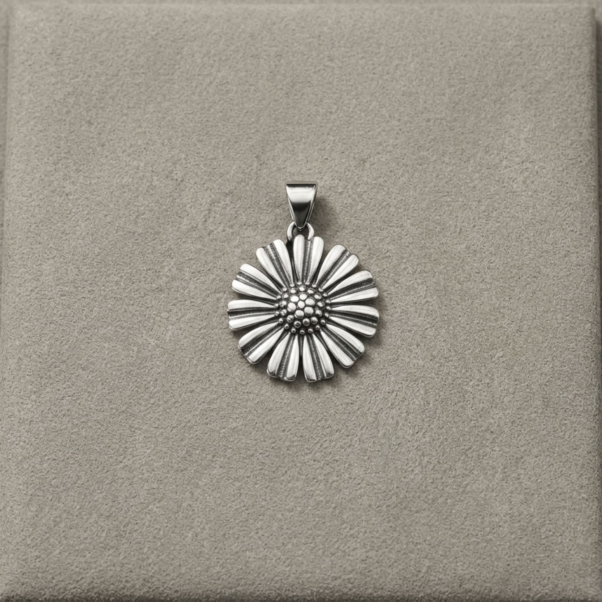 Silver-tone daisy pendant on bail, framed by scalloped petal design