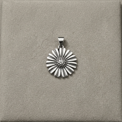 Silver-tone daisy pendant on bail, framed by scalloped petal design