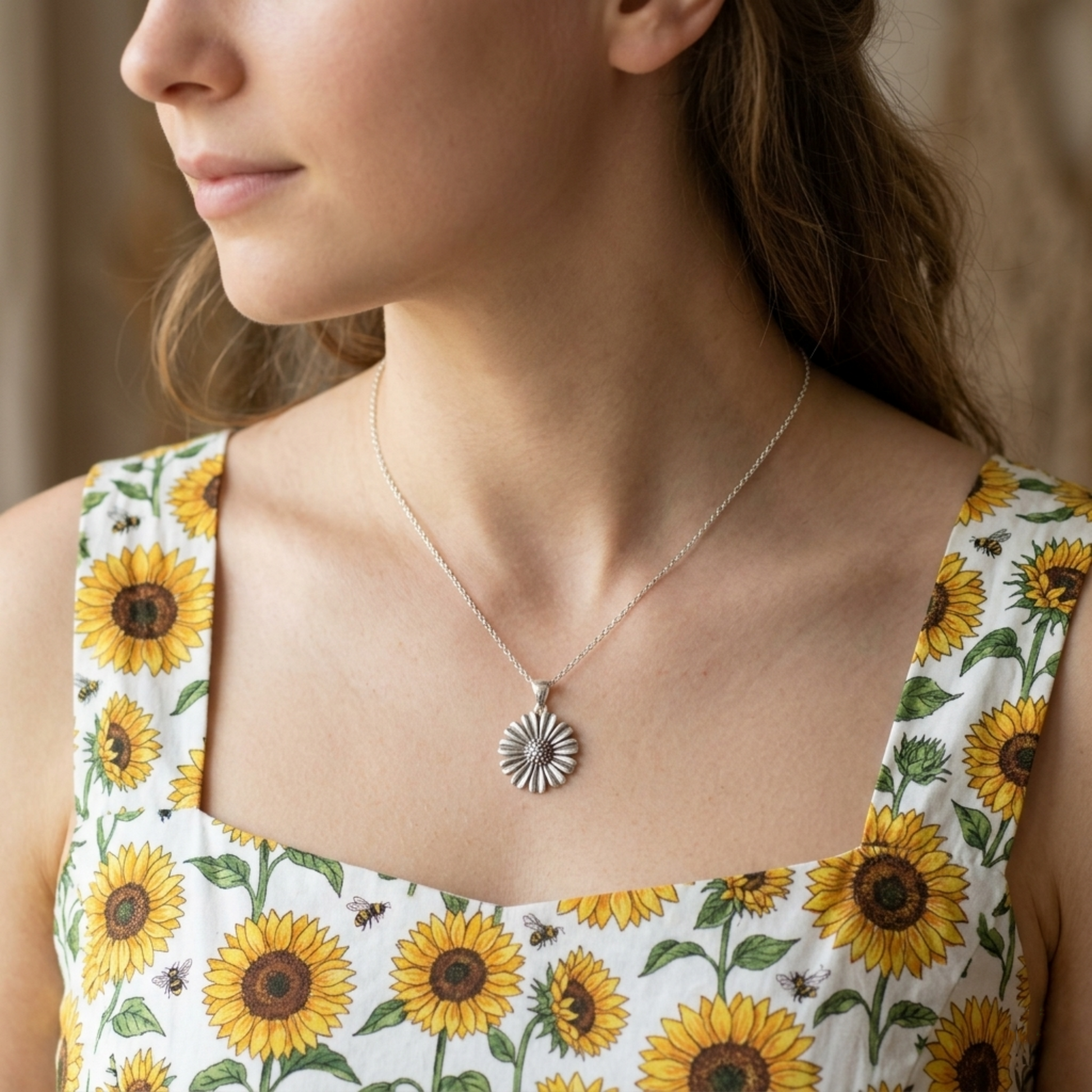 Daisy pendant necklace worn, silver-tone round center with scalloped petal rays