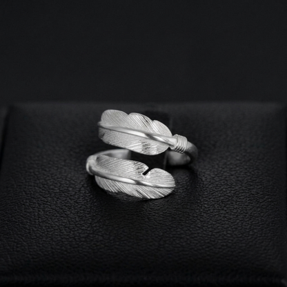 Double feather open band ring with twisted wrap, silver tone