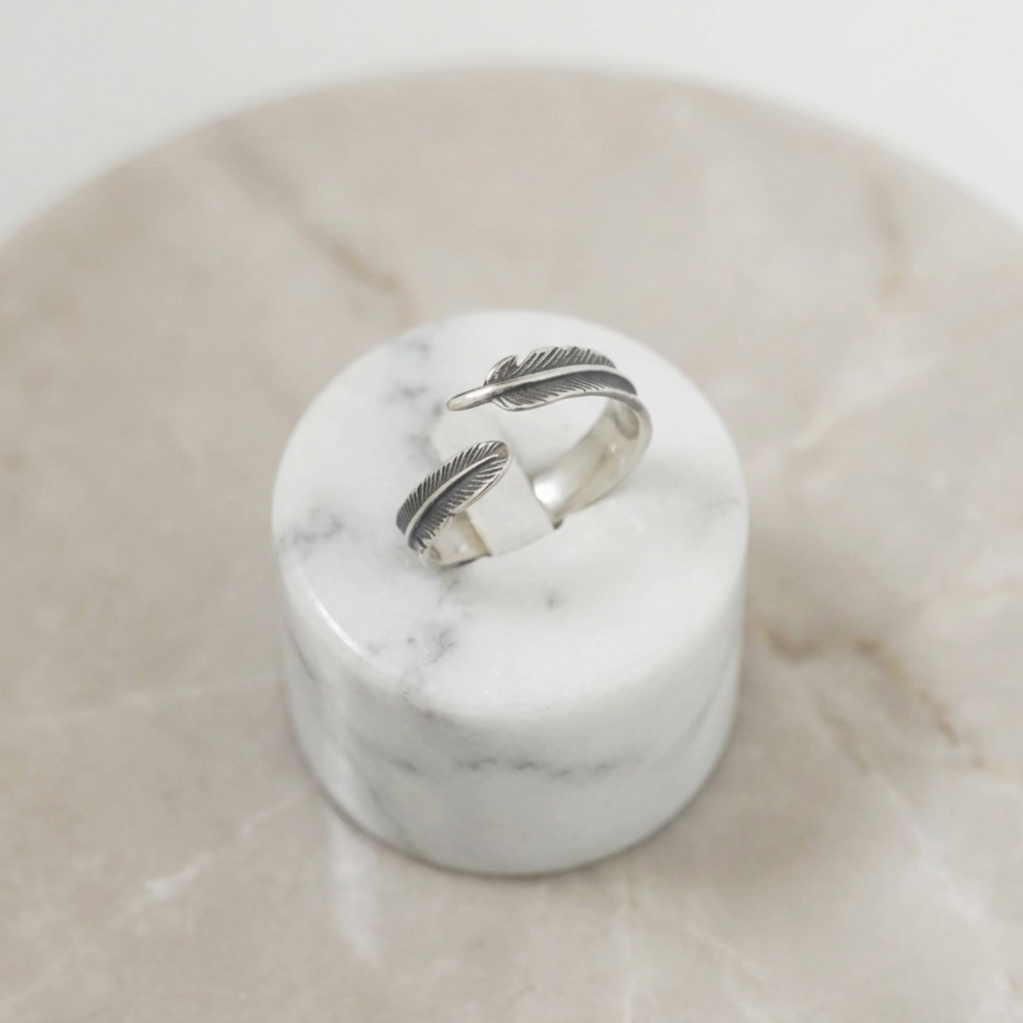Feather Wing Wrap Ring, zwei übereinanderliegende Federdetails auf schmalem Metallband