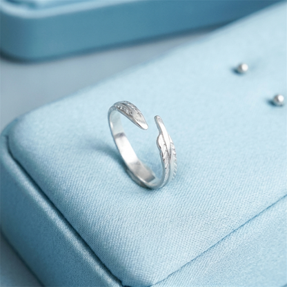 Angel feather wing open ring close-up, feather etching on the silver-tone band