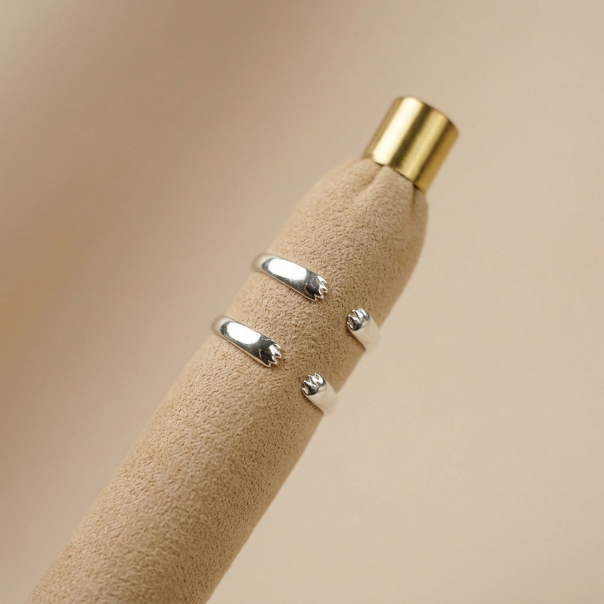 Silver-toned cat paw ring with black enamel accents, textured open band