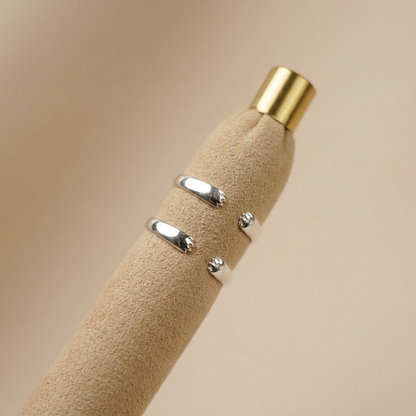 Silver-toned cat paw ring with black enamel accents, textured open band
