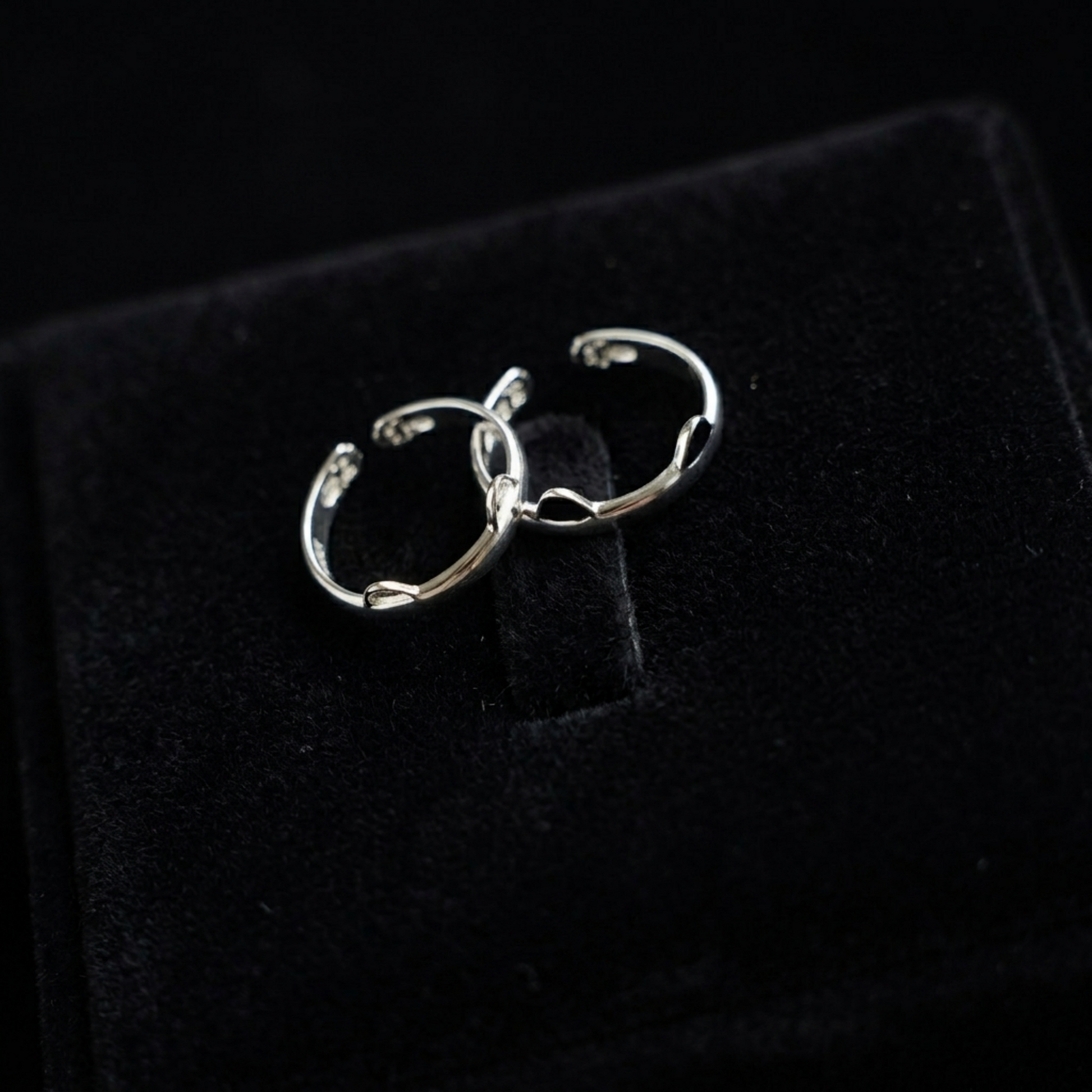 Silver-toned cat paw ring set with black enamel tips, small hoop style