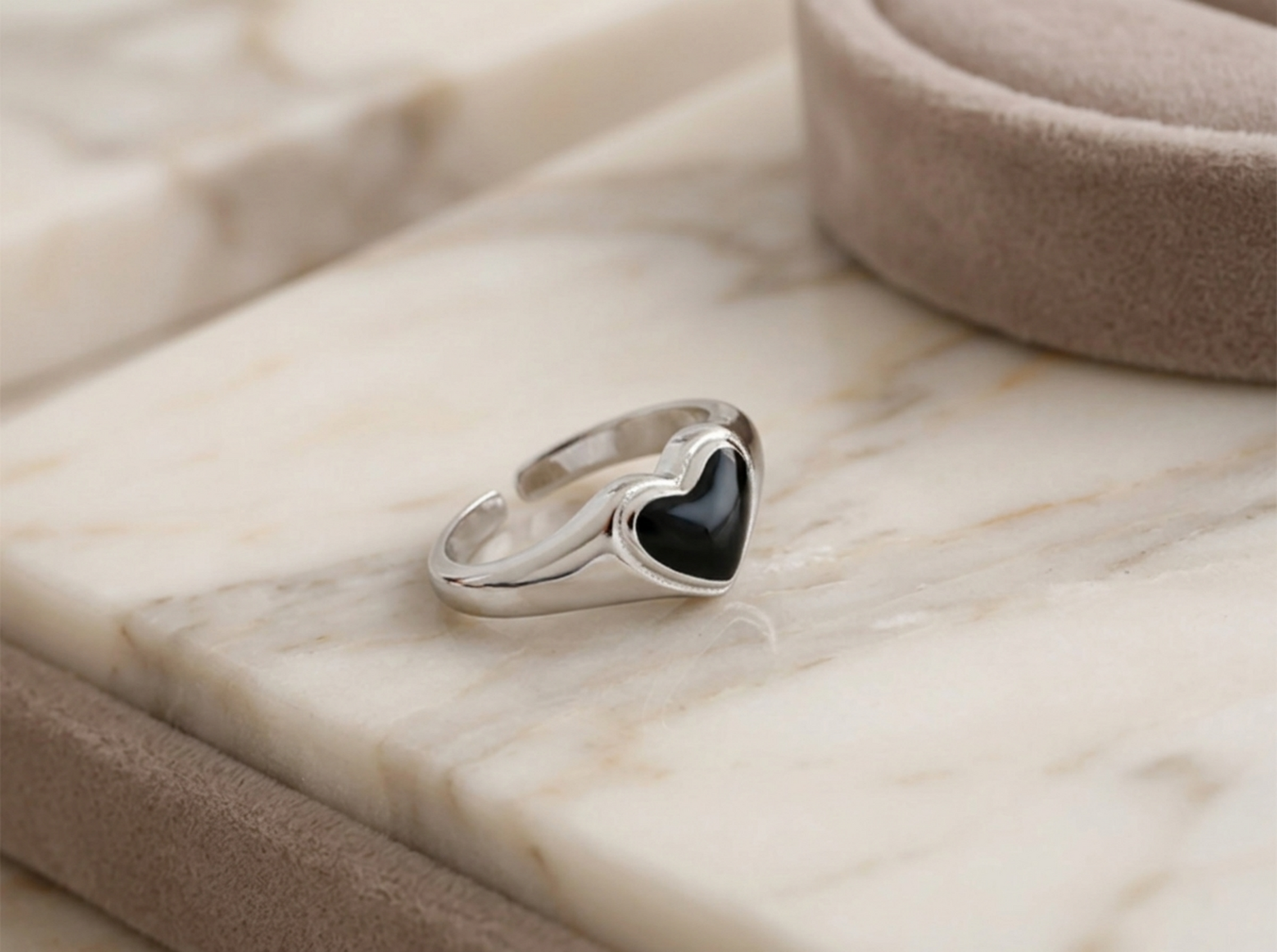 Wishbone heart ring viewed from side: black center inset in silver frame