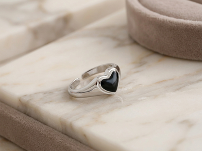 Wishbone heart ring viewed from side: black center inset in silver frame