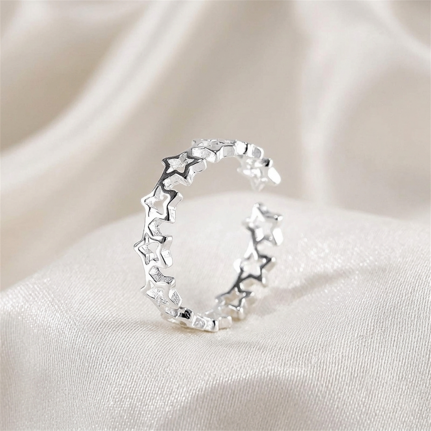 Silver-tone linked star ring shown from the side