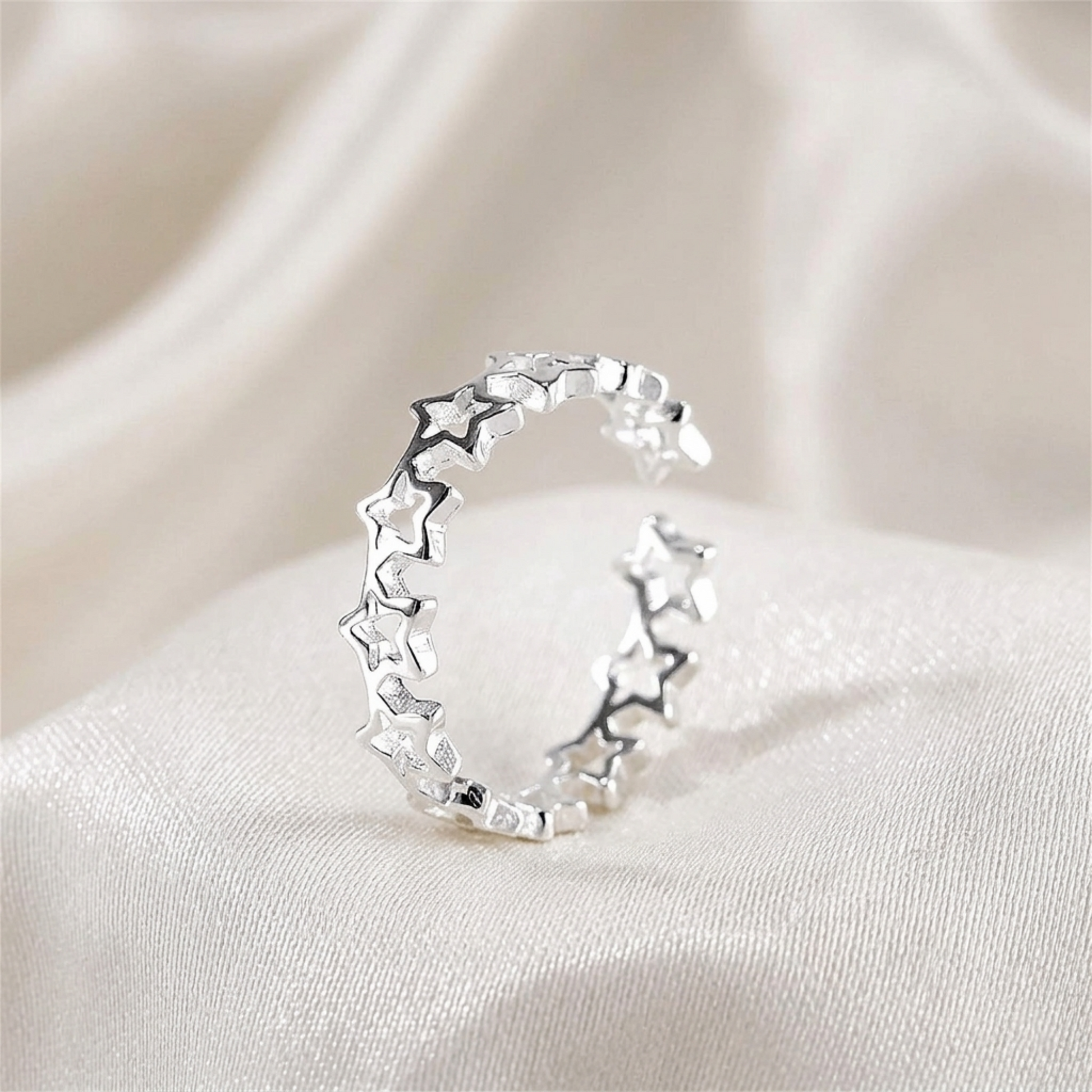 Silver-tone linked star ring shown from the side
