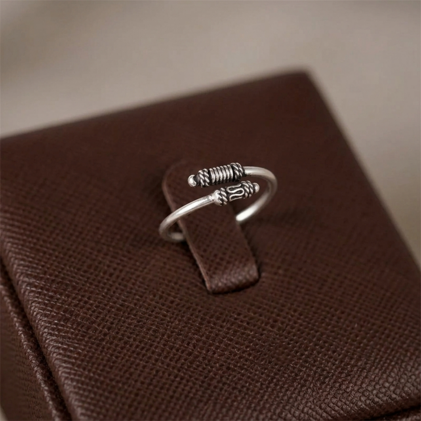 Oxidised Totem Knot ring, silver tone with spring-like ridges and knot centerpiece