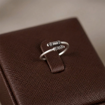 Oxidised Totem Knot ring, silver tone with spring-like ridges and knot centerpiece